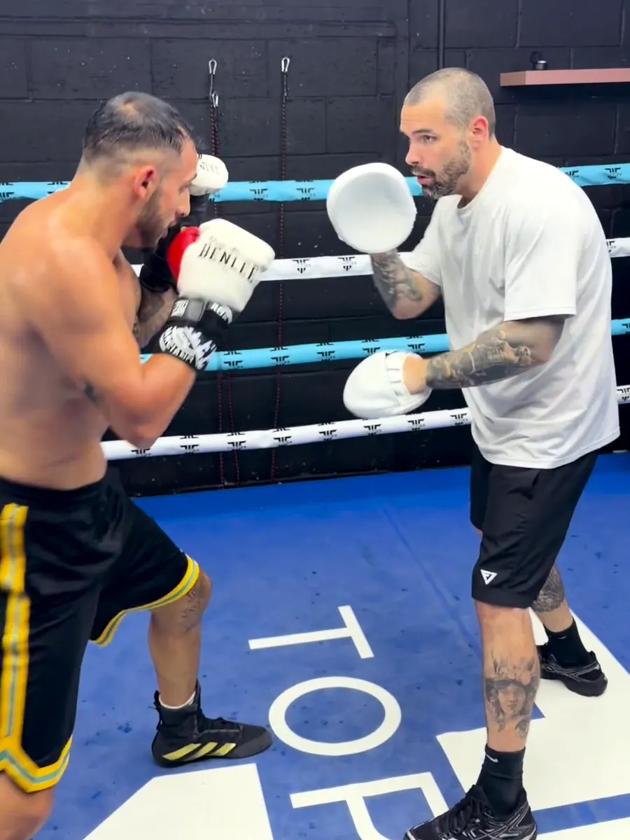 Marlee Dann holding pads for a professional boxer during a training session