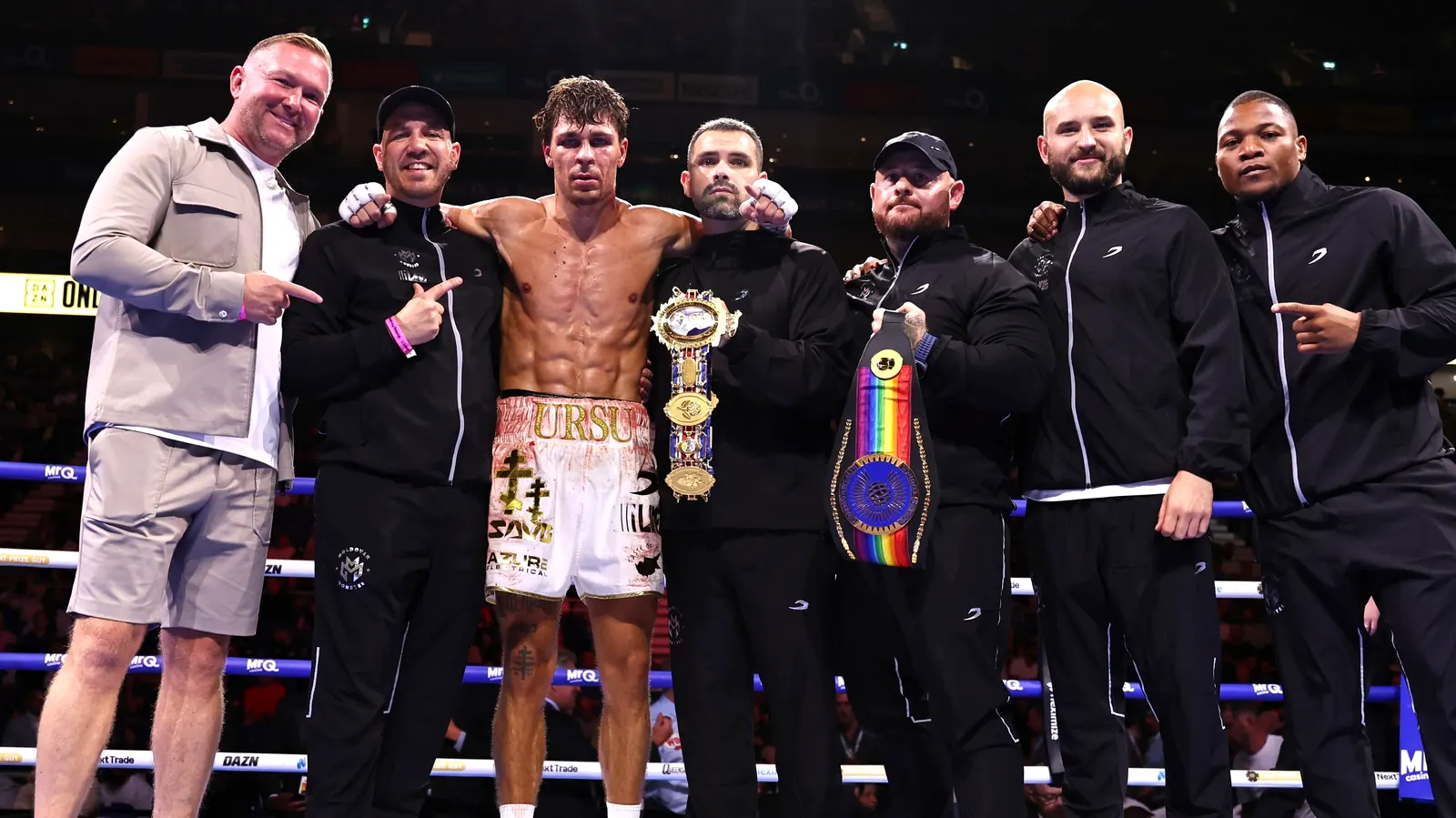 Constantin Ursu with his British and Commonwealth belts and team, including Marlee Dann, in the ring at The O2
